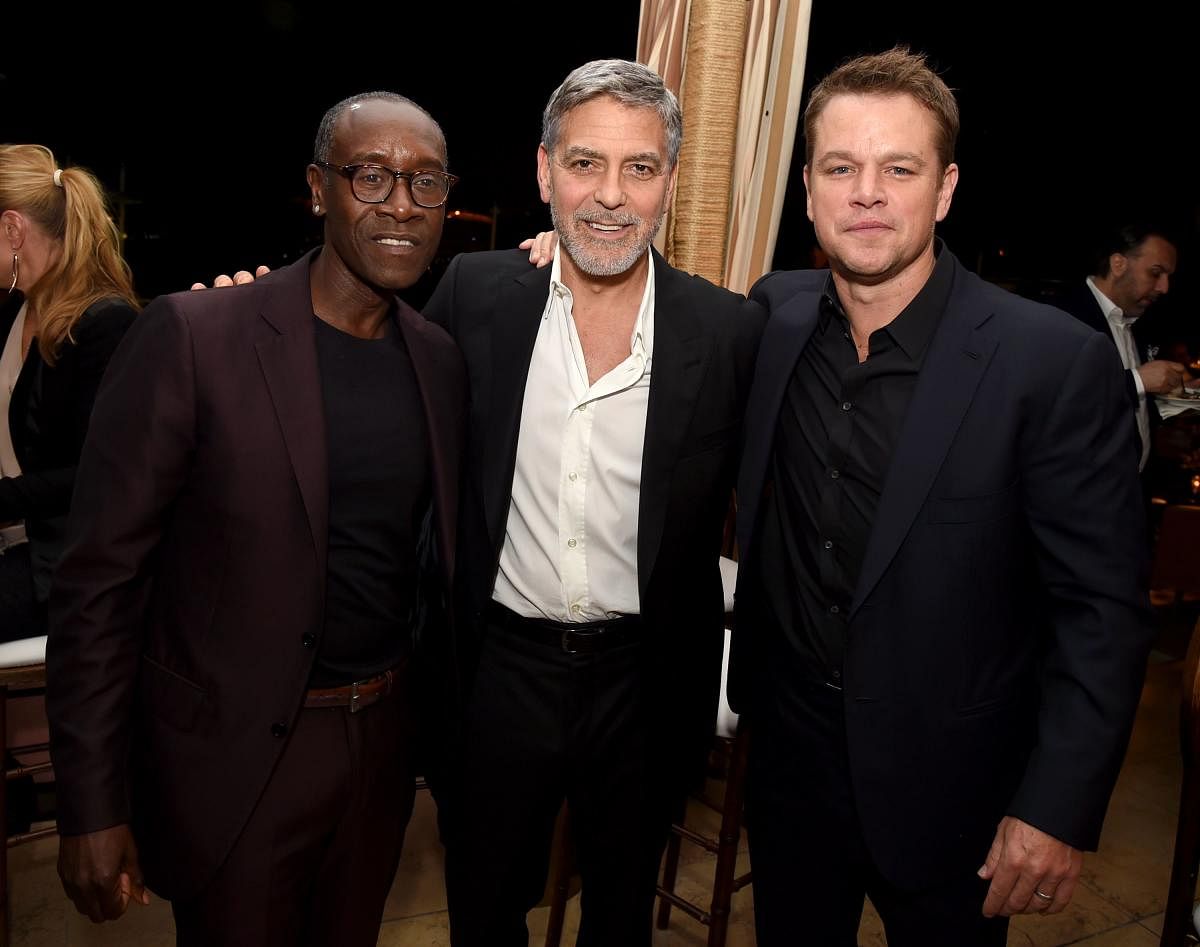 Don Cheadle, George Clooney and Matt Damon pose at the after party for the premiere of Hulu's "Catch-22" at the Sunset Towers on May 07, 2019 in West Hollywood, California. AFP