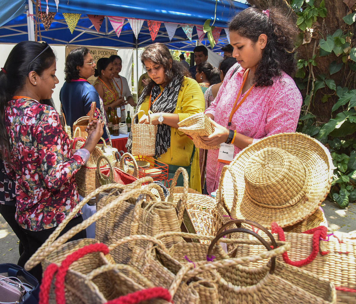 Crafts on display at the Social Start-Up Santhe at IIMB on Friday; (right) visitors enjoy tender coconut. DH photos/S K Dinesh