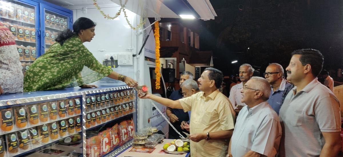 MLA K G Bopaiah launches the mobile shop featuring 'Yashaswi' brand of items prepared by the women victims of the natural calamity, in Madikeri, on Monday.