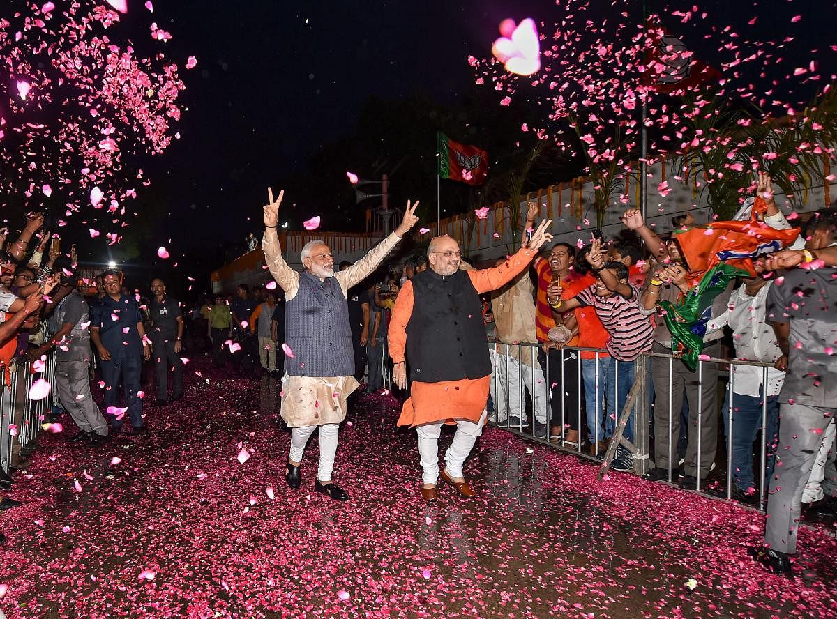 BJP workers welcome Prime Minister Narendra Modi and BJP President Amit Shah at the party headquarters to celebrate the party's victory in the 2019 Lok Sabha elections, in New Delhi on May 23, 2019. PTI