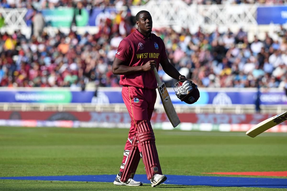 West Indies' Carlos Brathwaite walks back to the pavilion after losing his wicket for 16 during the 2019 Cricket World Cup group stage match between Australia and West Indies at Trent Bridge in Nottingham, central England, on June 6, 2019. (AFP)