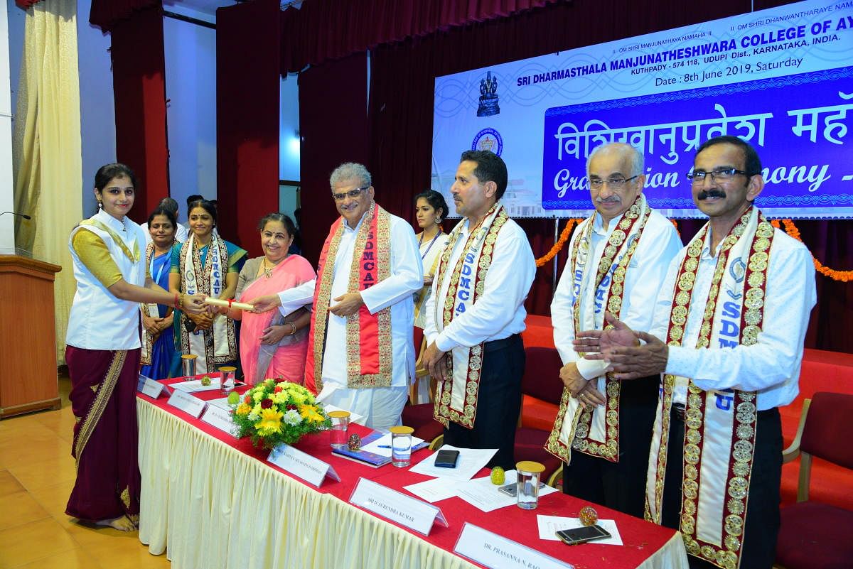 SDM University Chancellor D Veerendra Heggade hands over graduation certificate to a student during the 54th graduation ceremony of Sri Dharmasthala Manjunatheshwara (SDM) College of Ayurveda and Hospital at Kuthpady in Udupi on Saturday.