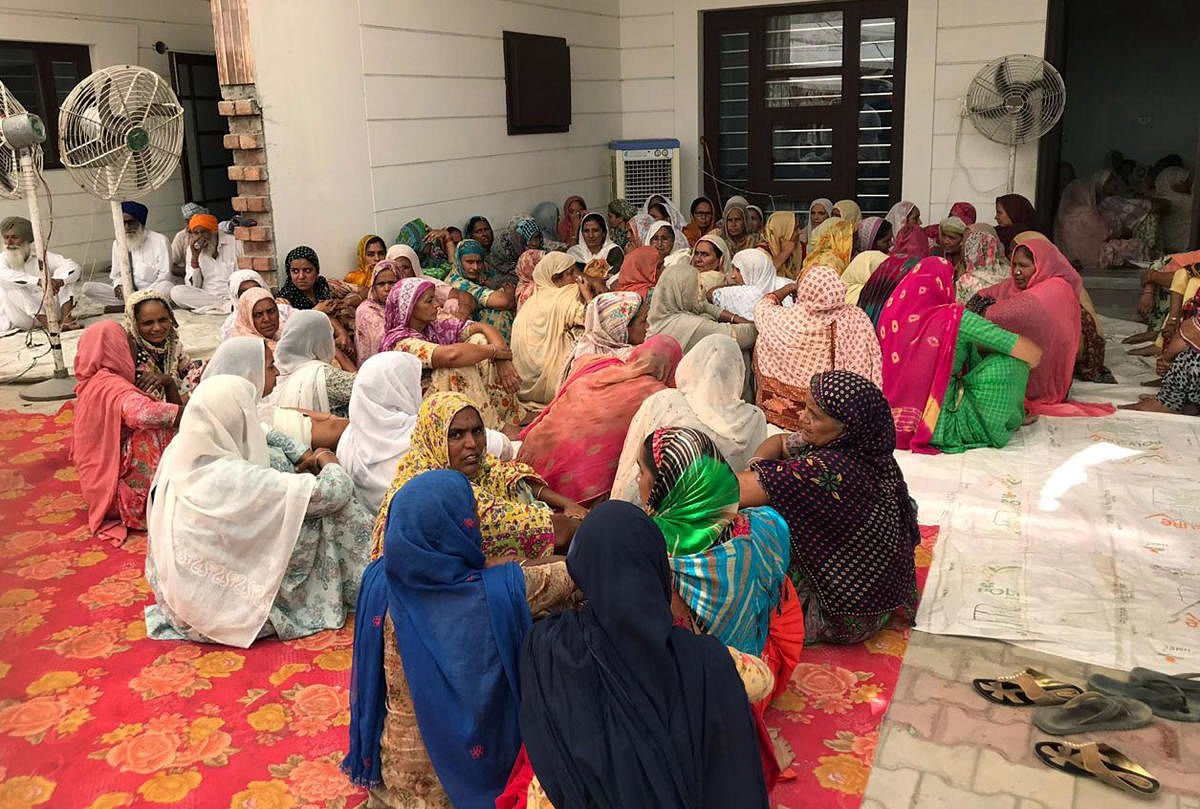 Sangrur: People gather at the residence of Fatehvir Singh, a two-year-old child who died after falling in a 150-foot-deep unused borewell, for the last rites in Sangrur district. (PTI Photo)