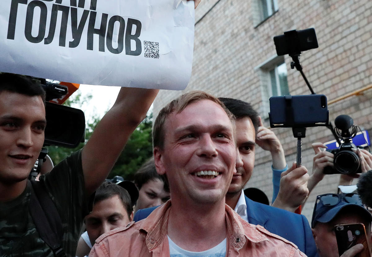 Russian journalist Ivan Golunov (R), who was freed from house arrest after police abruptly dropped drugs charges against him, meets with the media and his supporters outside the office of criminal investigations in Moscow, Russia June 11, 2019. The placar