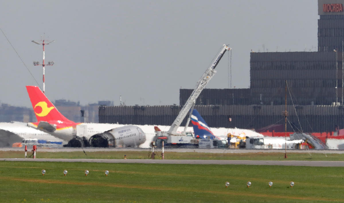 Members of emergency services operate a crane at the scene of an incident involving an Aeroflot Sukhoi Superjet 100 passenger plane at Moscow's Sheremetyevo airport (Reuters File Photo)
