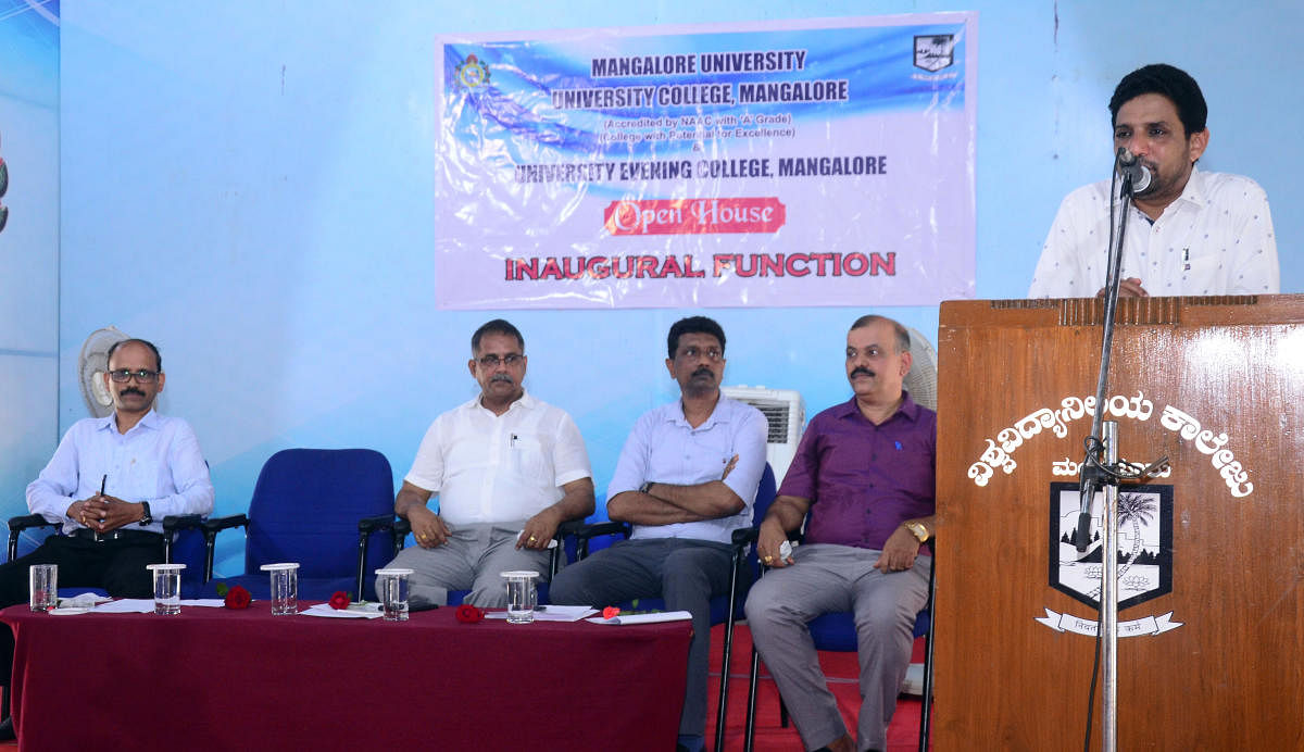 Dakshina Kannada District Information Officer B A Khader speaks after inaugurating Open House at the University College in Mangaluru.