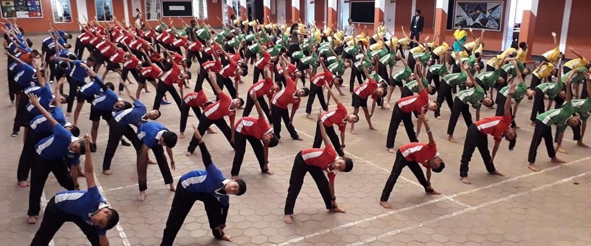 As many as 1,010 students of Coorg Public School in Gonikoppa perform Yogasanas under the guidance of teacher Manthava on Friday.