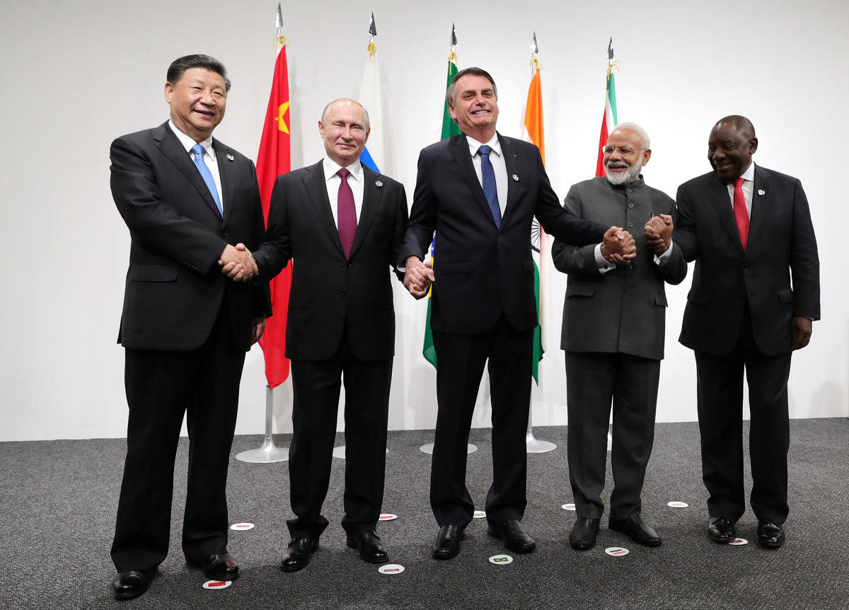 Russia's President Vladimir Putin (2nd L), Brazil's President Jair Bolsonaro (C), India's Prime Minister Narendra Modi (2nd R), China’s President Xi Jinping (L) and South Africa's President Cyril Ramaphosa pose for a picture during the BRICS summit in Osaka, Japan. Reuters photo