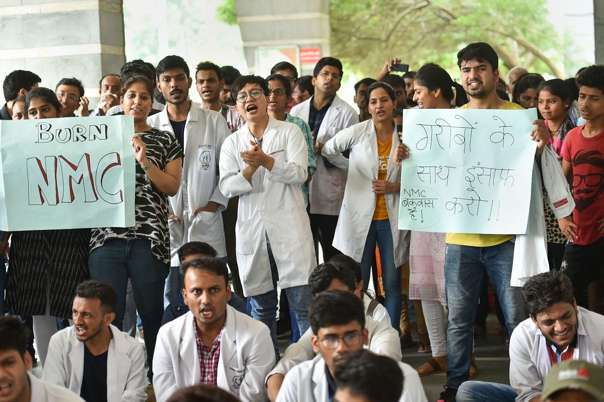 Federation of Resident Doctors Association raise slogans during a strike against National Medical Commission (NMC) Bill, at Safdarjung Hospital in New Delhi, Friday, Aug 2, 2019. (PTI Photo/Arun Sharma)
