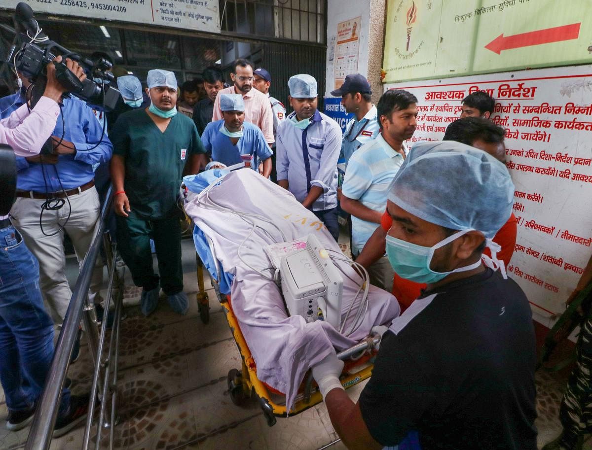 Unnao rape survivor's lawyer being shifted to an ambulance outside the KGMC Trauma Centre before being airlifted to New Delhi for further treatment (PTI file photo)
