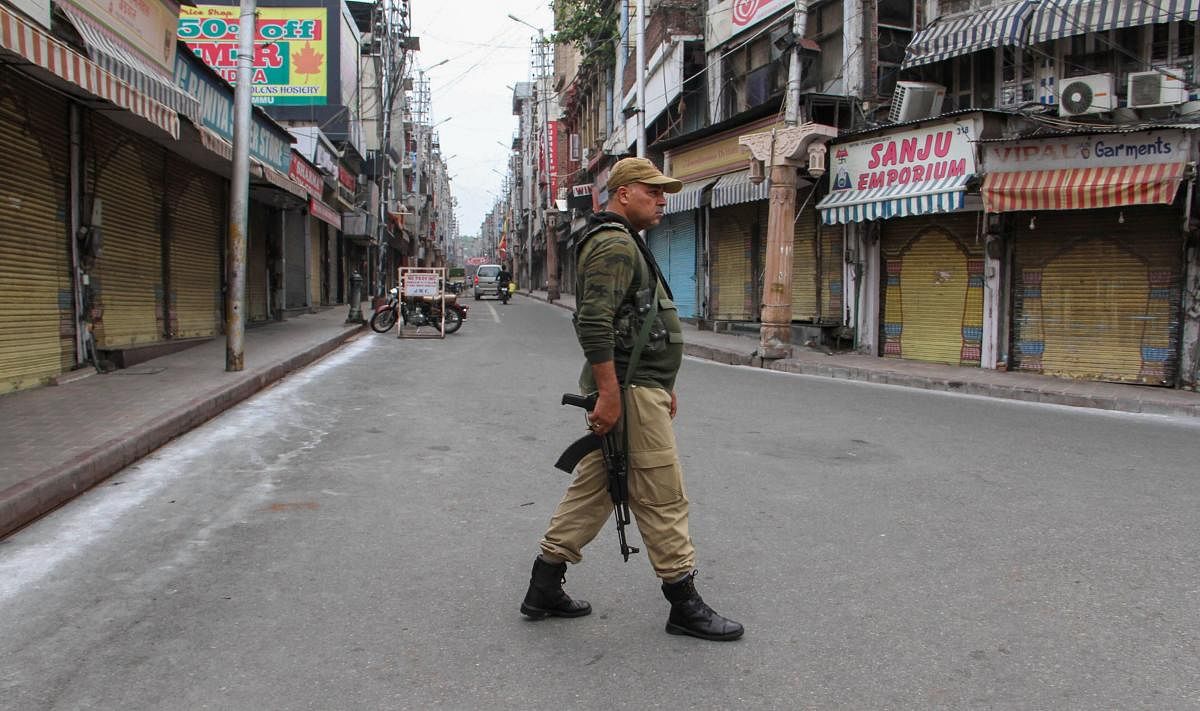Security personnel stand guard during restrictions, in Jammu, Friday Aug 9, 2019. (PTI Photo)