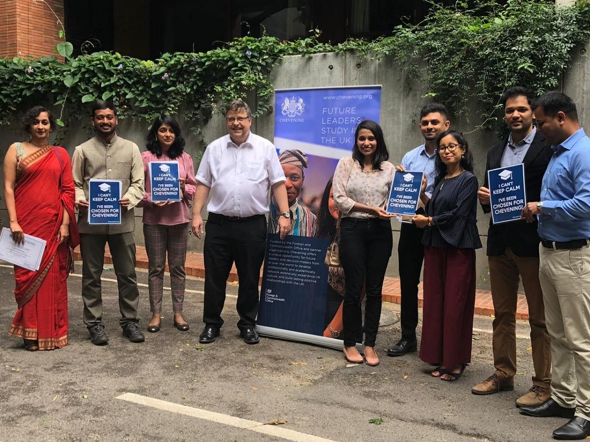 British Deputy High Commissioner Dominic McAllister stands with seven Bengaluru-based Scholars who have been selected for the 2019-2020 Chevening Scholarships, in front of the British Council offices, in Bengaluru on July 9, 2019.