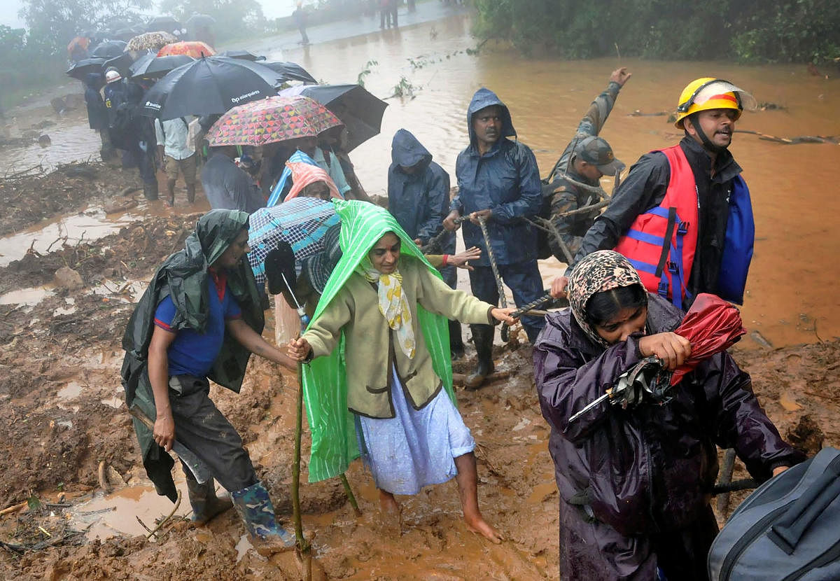 Chikmagalur: Army and fire brigade personnel carry out rescue works in flood and landslide-hit Allekahan Horate village in Mudigere taluk near Chikmagalur, Sunday, Aug 11, 2019. (PTI Photo) (PTI8_11_2019_000188A)
