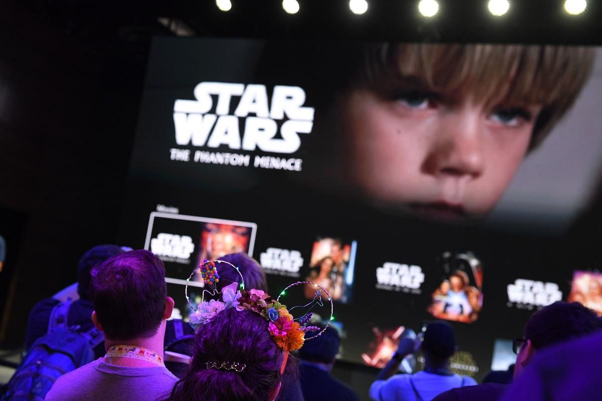 Attendees get a preview of the Disney+ streaming service interface at the D23 Expo, billed as the "largest Disney fan event in the world," August 23, 2019 at the Anaheim Convention Center in Anaheim, California. (Photo by AFP)