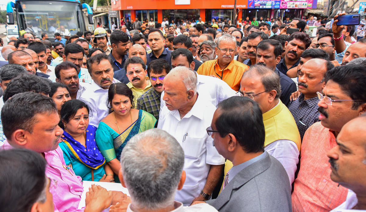 B S Yediyurappa talks to members of the public during his city rounds on Sunday. (R) The chief minister travelled by a BMTC Volvo bus to get a feel of the traffic. DH PHOTOS/ANUP R THIPPESWAMY