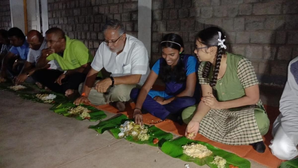 Minister for Primary and Secondary Education Suresh Kumar has a meal with schoolchildren in Madikeri.