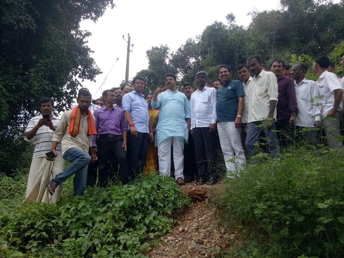 Revenue Minister R Ashoka inspects the damaged hanging bridge across River Nethravathi near Uppinangady on Monday.