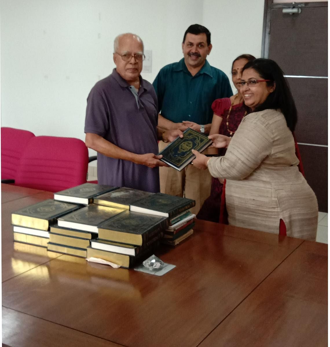 John B Monteiro of Johnlyn Toy Exchange and Book Bank hands over books to an educational institution in Mangaluru. 