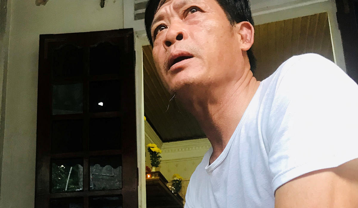 Pham Van Thin, father of Pham Thi Tra My, a victim of 39 deaths on a truck container in UK, sits at home in Ha Tinh province, Vietnam. (Photo by REUTERS)