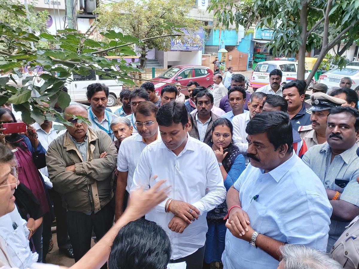 Mayor Gowtham Kumar and MLA S Raghu speak to the protesters at Indiranagar on Thurdsay. special arrangement