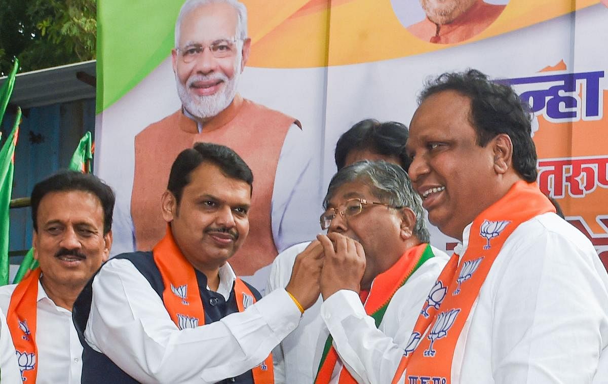 Mumbai: Newly sworn-in Maharashtra Chief Minister Devendra Fadnavis being greeted by BJP supporters on his arrival at state's BJP office, in Mumbai, Saturday, Nov. 23, 2019. In a stunning turn of events, early morning, Fadnavis and NCP leader Ajit Pawar t