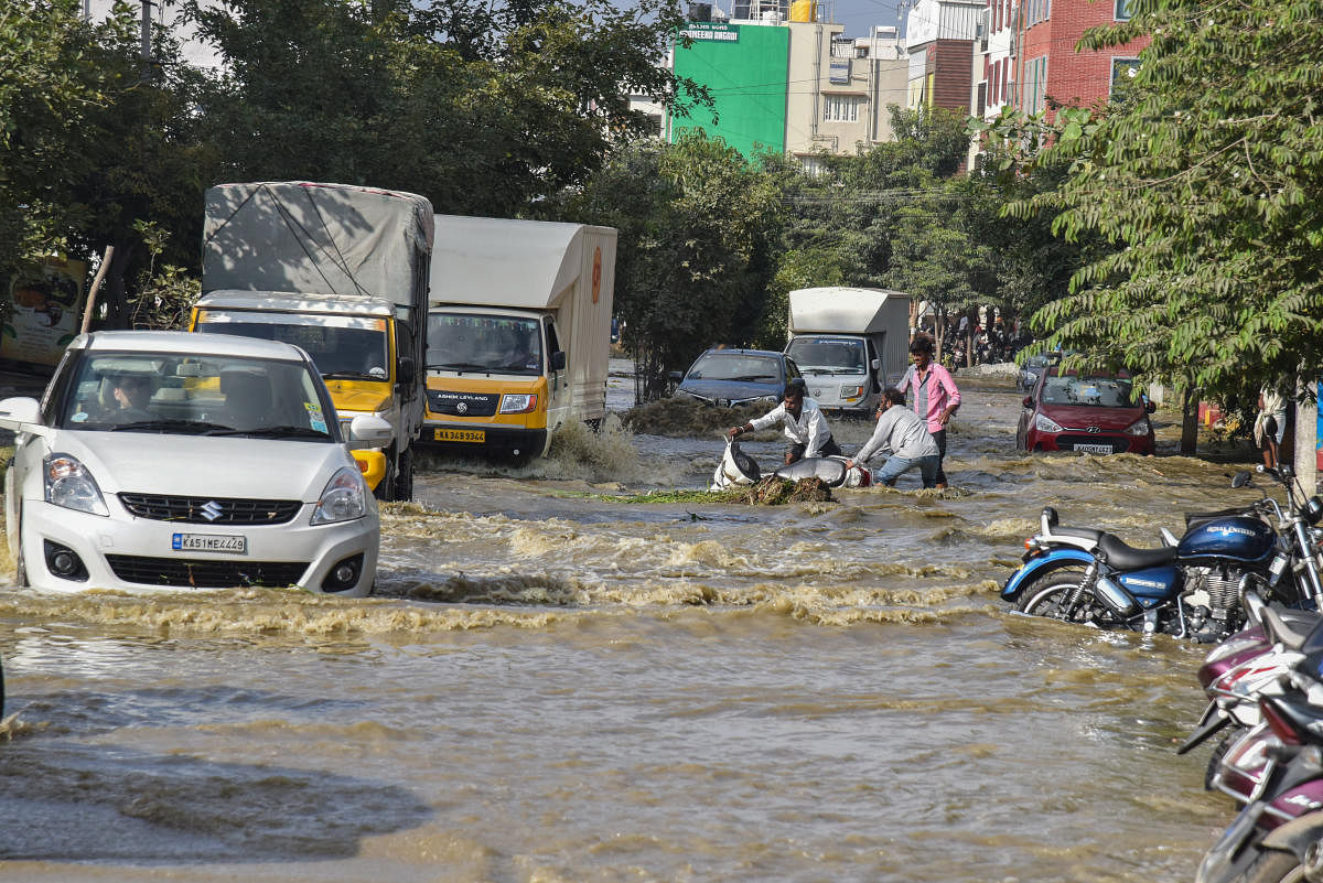 A road which was flooded after the Hulimavu Lake breached. DH Photo/ S K Dinesh