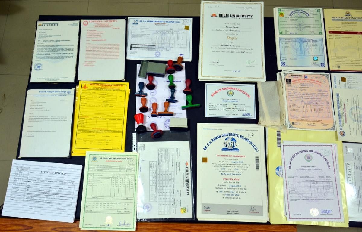 The fake degree marks cards and rubber-stamps seized from G Srinivasa Reddy (inset). PHOTO COURTESY: CCB