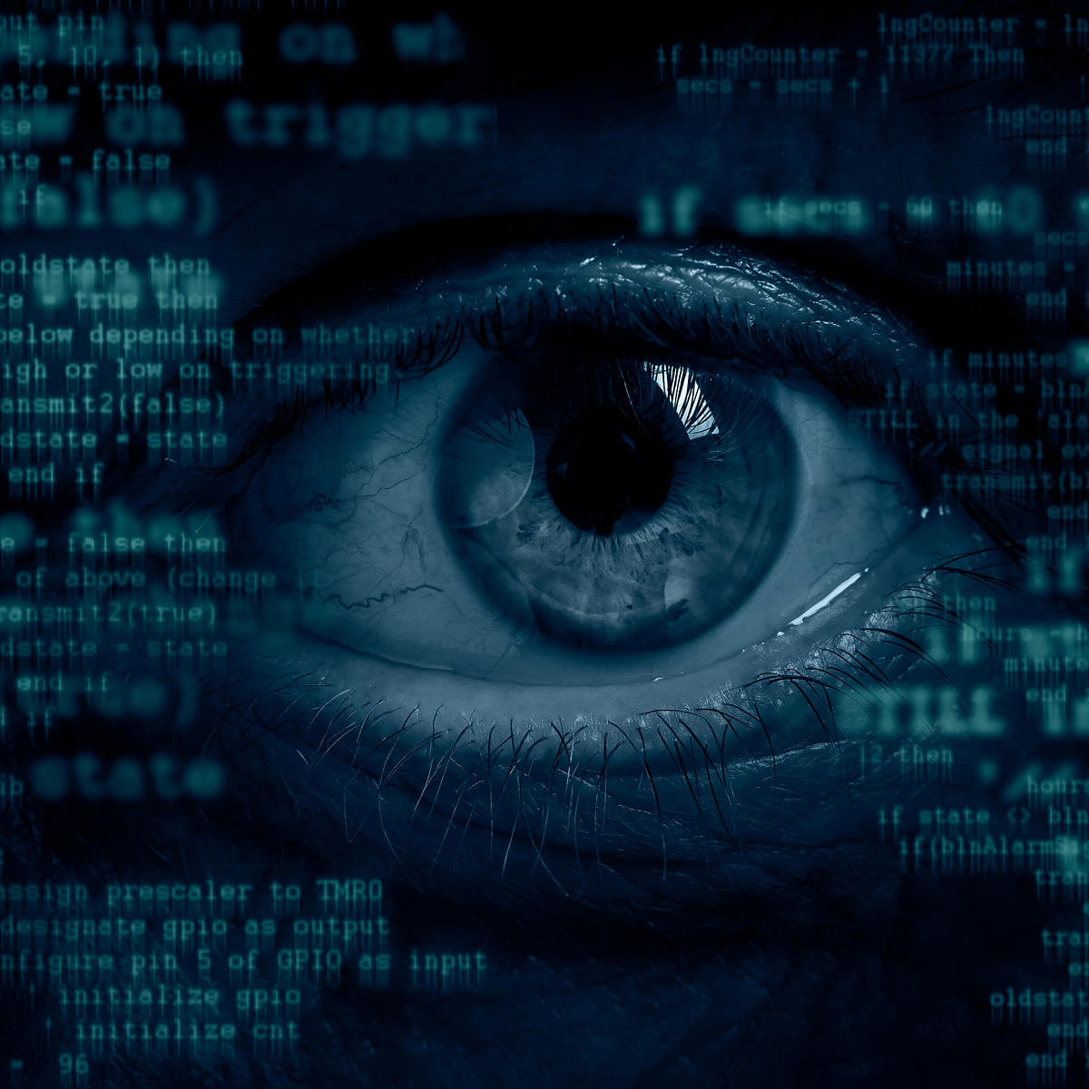 Male eye peeking throuth computer screen. Global surveillance or cybercrime concept.books