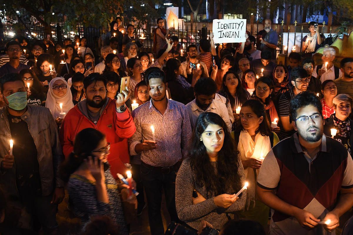 Citizens during a candlelight vigil for victims of police brutality in Bengaluru on Tuesday. DH PHOTO/PUSHKAR V