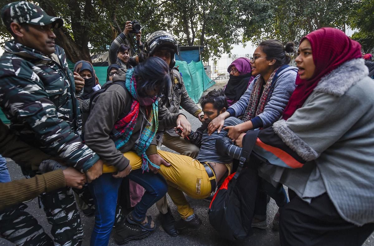 Police personnel detain a protestor taking part in a march demanding for the release of Bhim Army leader Chandrasekhar Azad and against the amended Citizenship Act, NRC and NPR, in New Delhi, Friday, Dec. 27, 2019. (PTI Photo)