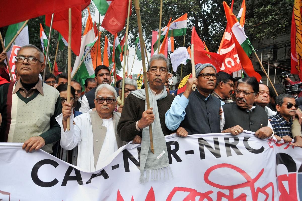 Left Front Chairman Biman Bose, West Bengal Congress President Somen Mitra and others participate in a joint protest against CAA, NRC and NPR in Kolkata, on Friday. PTI