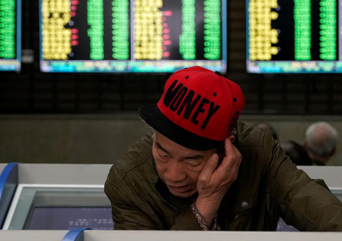 An investor looks at computer screens showing stock information at a brokerage house in Shanghai, China May 6, 2019. (Reuters Photo)