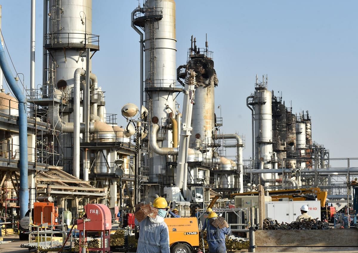 This file photo taken on September 20, 2019 shows employees of Aramco oil company working in Saudi Arabia's Abqaiq oil processing plant. (Photo by Fayez Nureldine / AFP)