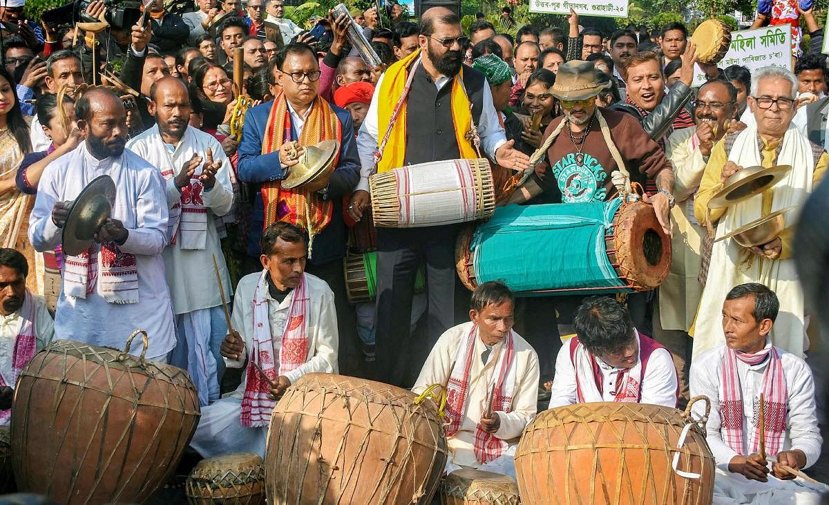 Singer Zubeen Garg with All Assam Students Union (AASU) chief advisor Samujjal Bhattcharjya and AASU President Dipankar Kumar Nath and other artists from different part of Assam play traditional instruments during the 'Ran Singa' protest against the Citizenship (Amendment) Act (CAA), in Guwahati, Thursday, Jan. 9, 2020. (PTI Photo)