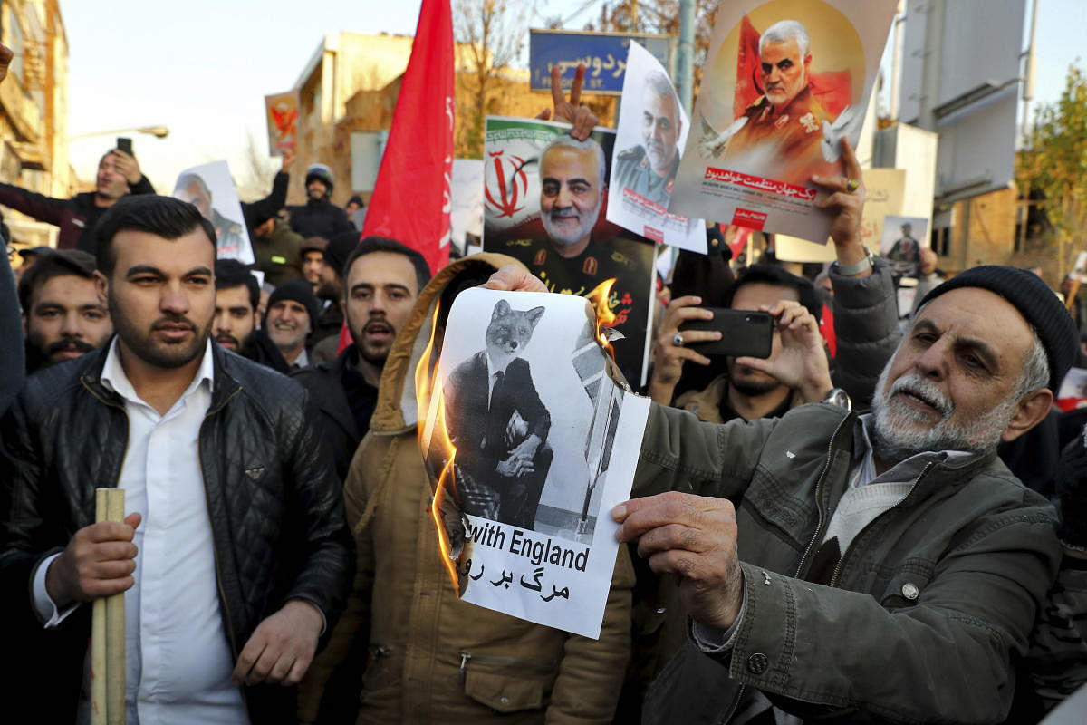 A hardline protester burns an anti-UK placard in front of British Embassy in Tehran, Iran, Sunday, Jan. 12, 2020. (AP/PTI Photo)