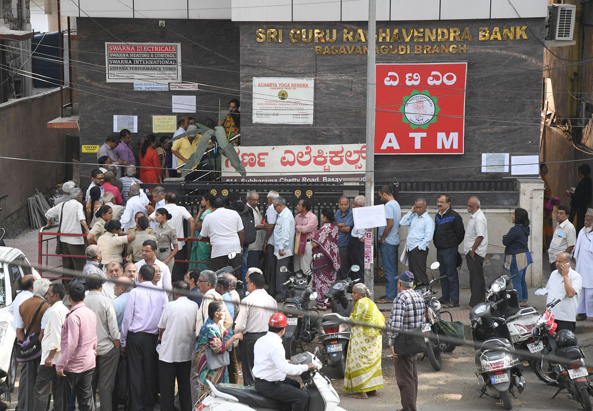 Depositors in front of Sri Gururaghavendra Co-operative Bank in Bengaluru. DH Photo