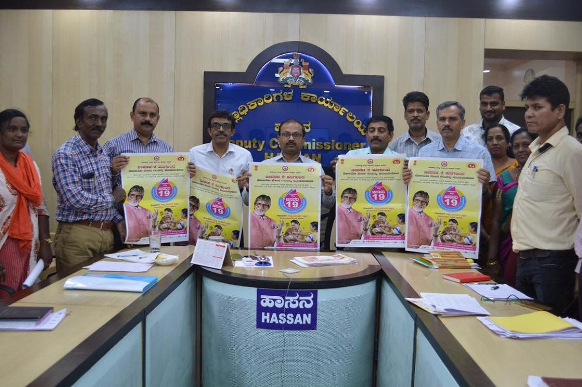 Deputy Commissioner R Girish released the poster on Pulse Polio drive in Hassan on Wednesday. dh photo