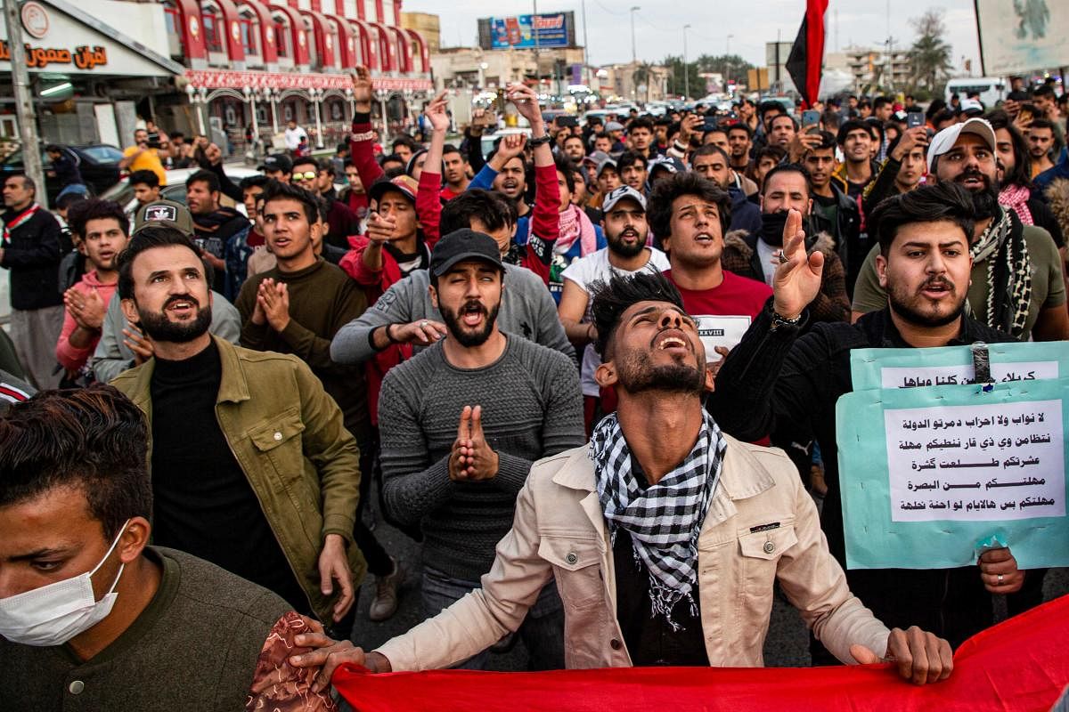 Protesters chant slogans as they march during an anti-government demonstration, also calling for freedom of the press, in the southern Iraqi city of Basra on January 17, 2020. (AFP Photo)