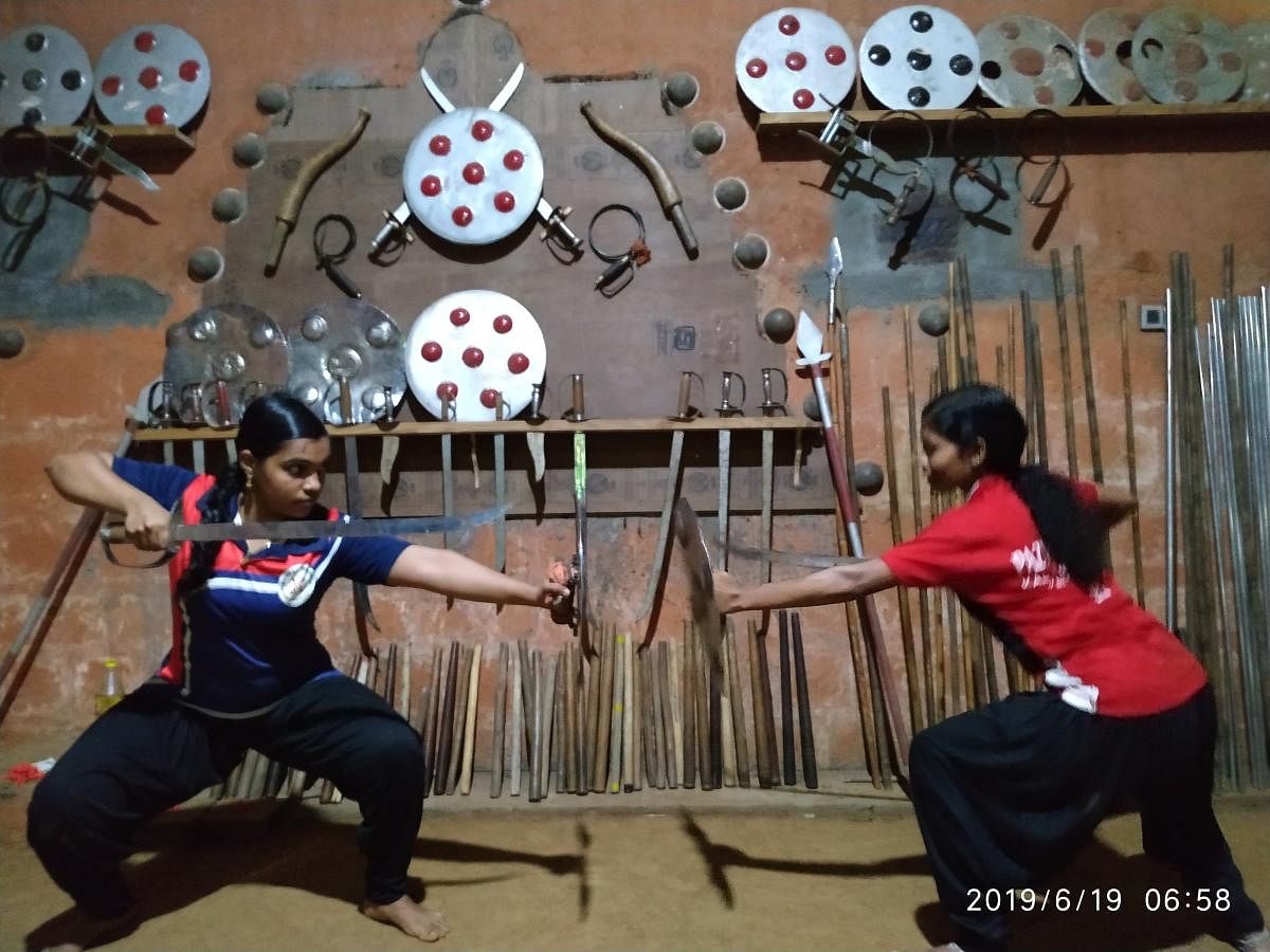 Anushree and Archa wield a sword and a shield in a combat exercise.