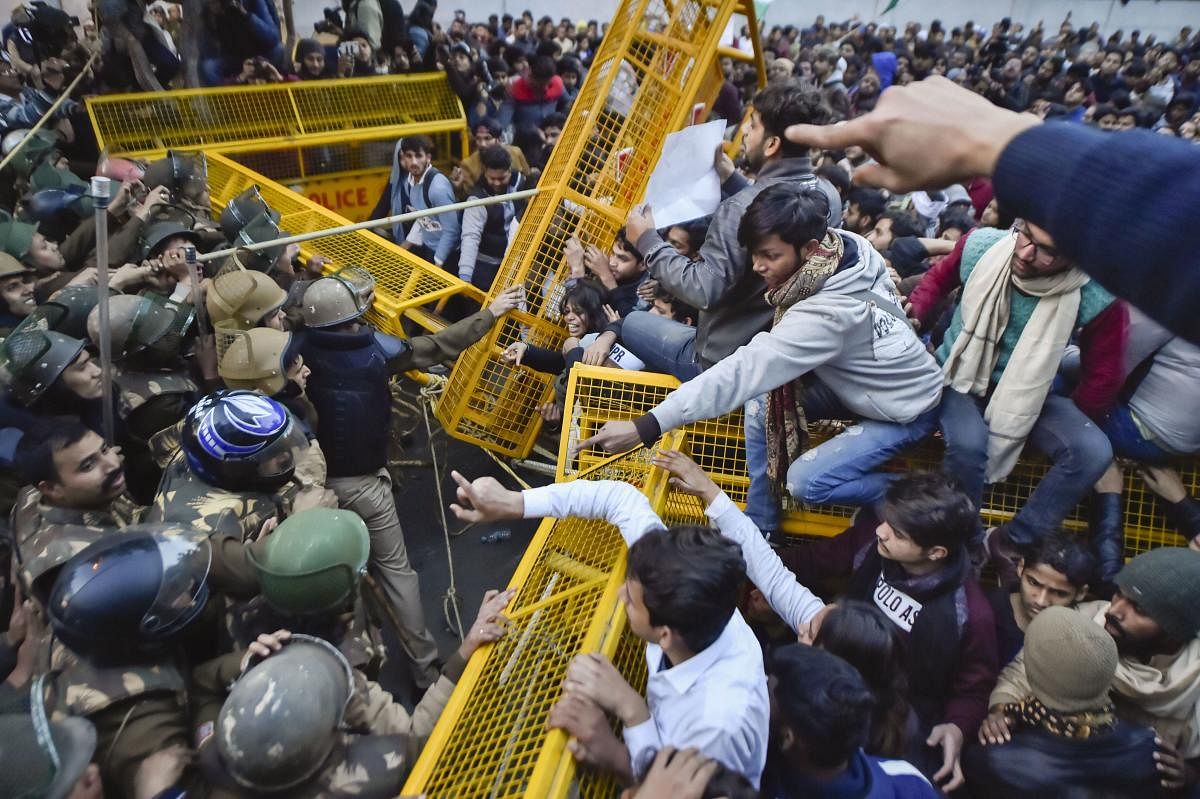 Students try to breach the police barricading during their protest march against the Citizenship Amendment Act and National Register of Citizens (NRC), near Jamia Millia Islamia university in New Delhi, Thursday, Jan. 30, 2020. (PTI Photo)