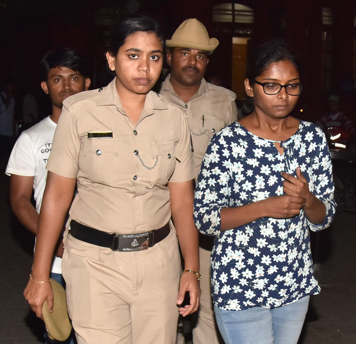 Police take Amrita Chandrashekar and her friend Sridhar Rao to court on Friday. DH Photo/Janardhan B K