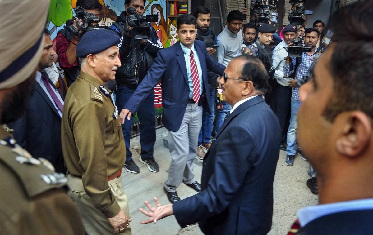 National Security Advisor (NSA) Ajit Doval interacts with Special Commissioner of Police in Delhi S.N. Srivastava during his visit to the riot affected areas to assess ground situation, in north east Delhi, Wednesday, Feb. 26, 2020. (PTI Photo)