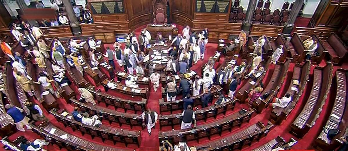 Opposition members protest in the well of Rajya Sabha during the Budget Session of Parliament, in New Delhi, Monday, March 2 , 2020. (RSTV/PTI Photo)