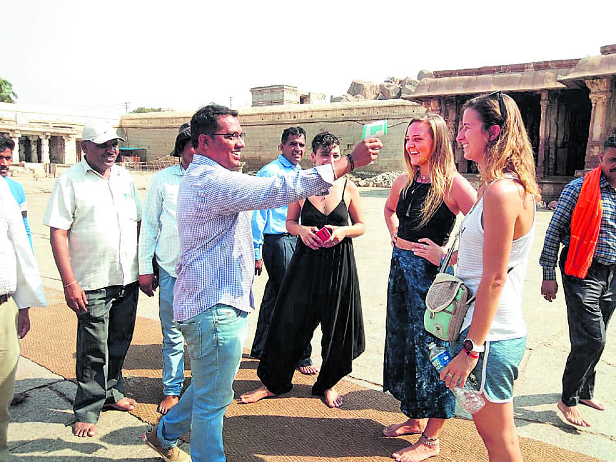 A doctor examines a foreign tourist at Hampi in Hosapete taluk of Ballari district on Tuesday. DH Photo