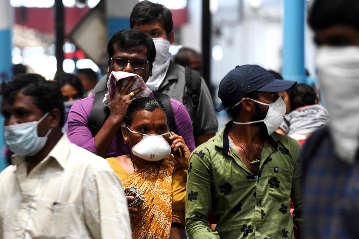 Passengers wear facemasks amid concerns over the spread of the COVID-19 novel coronavirus at M.G.R.Central railway station in Chennai on March 16, 2020. (Photo by AFP)