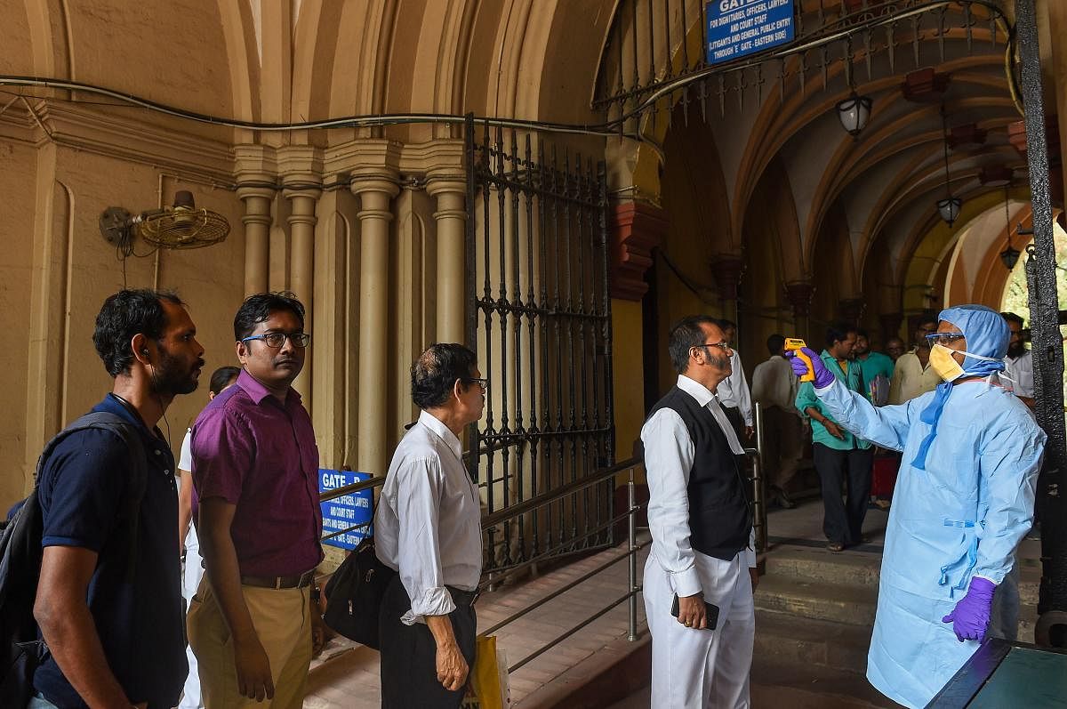 Thermal screening being conducted on visitors, in the wake of deadly coronavirus, at the entrance gate of Calcutta High Court in Kolkata. (PTI Photo)