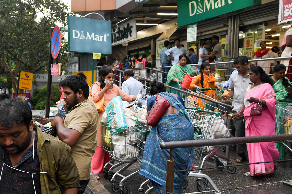 People scrambling to buy groceries was a common sight at many supermarkets on Friday. DH Photo/ B H Shivakumar