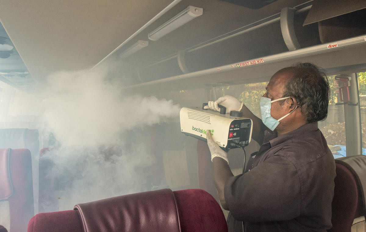 A worker fumigates a KSRTC bus at the Shanthinagar Bus Station in Bengaluru on Saturday. DH PHOTO/IRSHAD MAHAMMAD