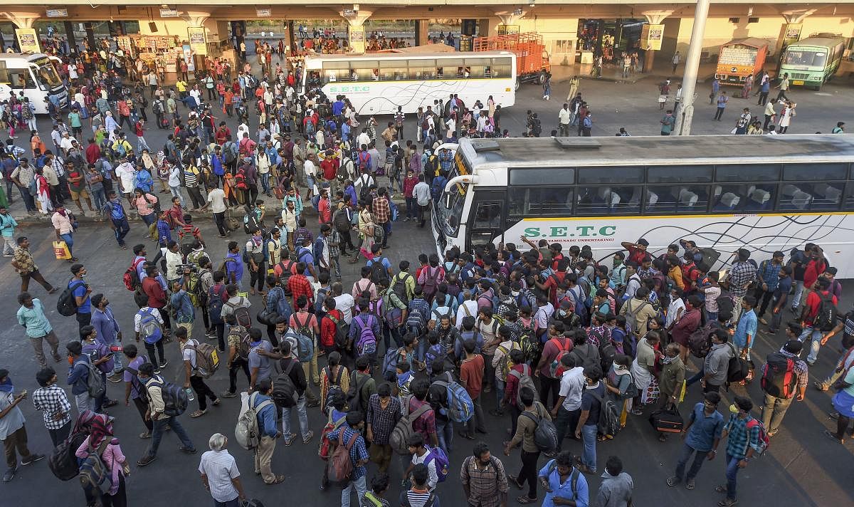 assengers rush to board State Express Transport Corporation of Tamilnadu (SETC) buses after lockdown announcement in view of coronavirus pandemic, at Koyambedu bus terminal, in Chennai. Tamil Nadu will be under a lockdown till March 31 from 6 PM on Tuesday to prevent the spread of coronavirus and CrPC section 144 will be invoked for its implementation. (PTI Photo)