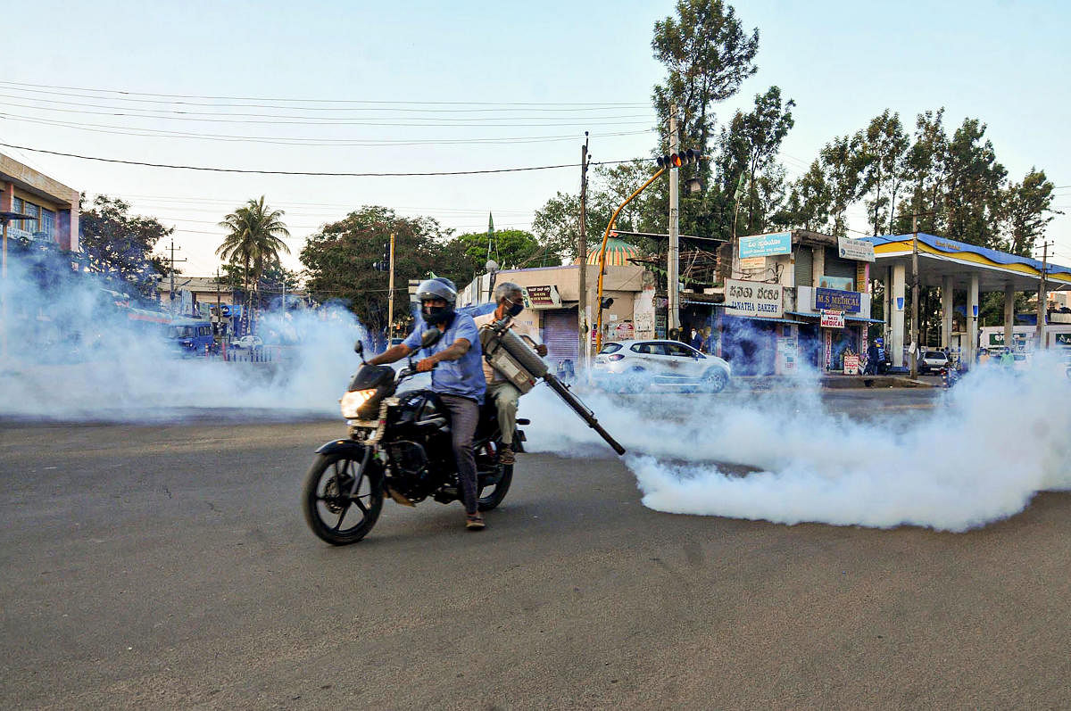 Health workers disinfect a street in the wake of coronavirus in Chikmagalur on Saturday. PTI